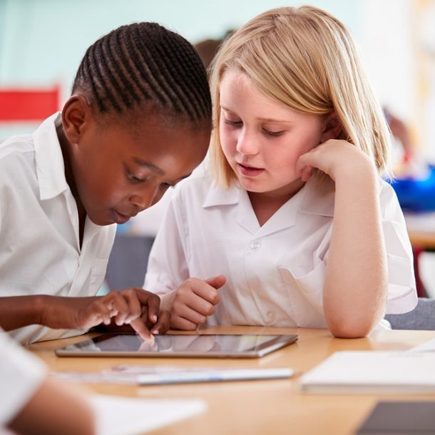 Two students using a tablet in class
